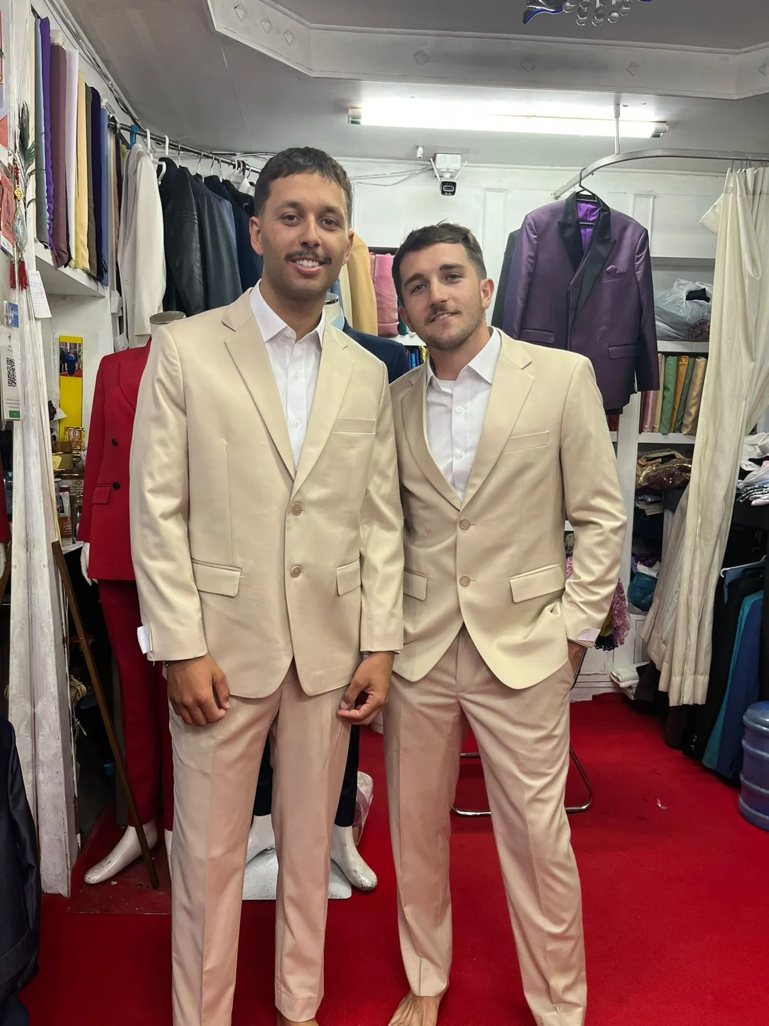 Two young men in matching beige custom suits at Oslo Tailor, Patong