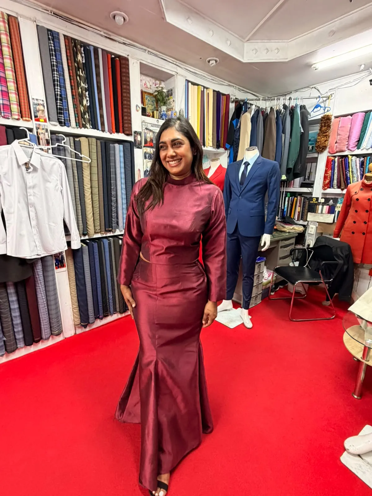 Customer fitting a wine-coloured two-piece set at Oslo Tailor, Patong